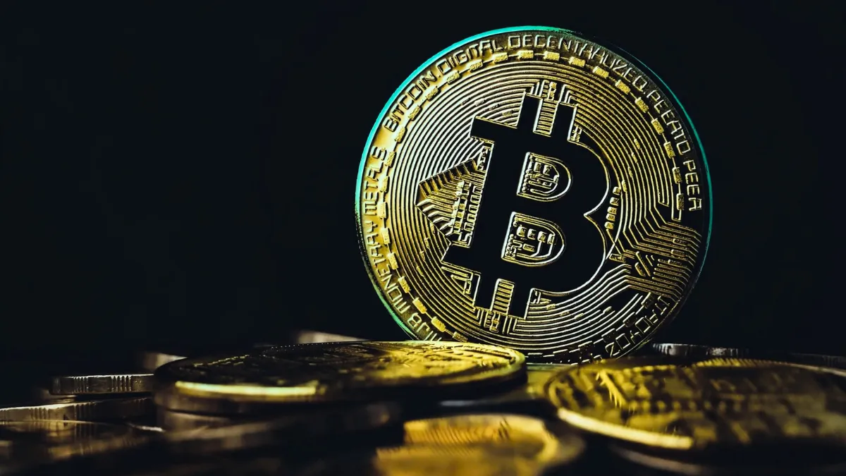Bitcoin coin representing decentralized digital currency and its key features against a dark background